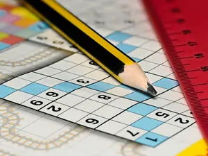 Sudoku a medio resolver con un lápiz y una regla roja